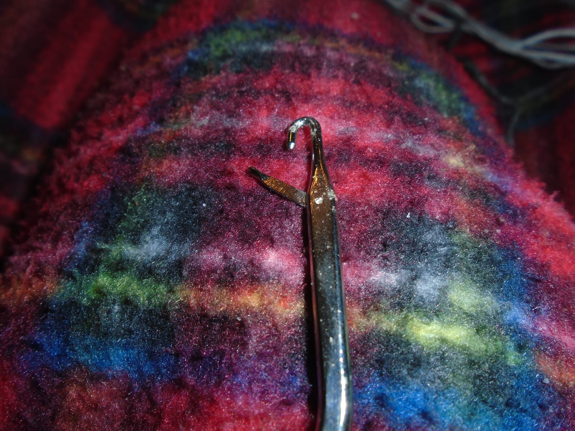Close-up showing the hook at the end and the latch, half open and free to swing.