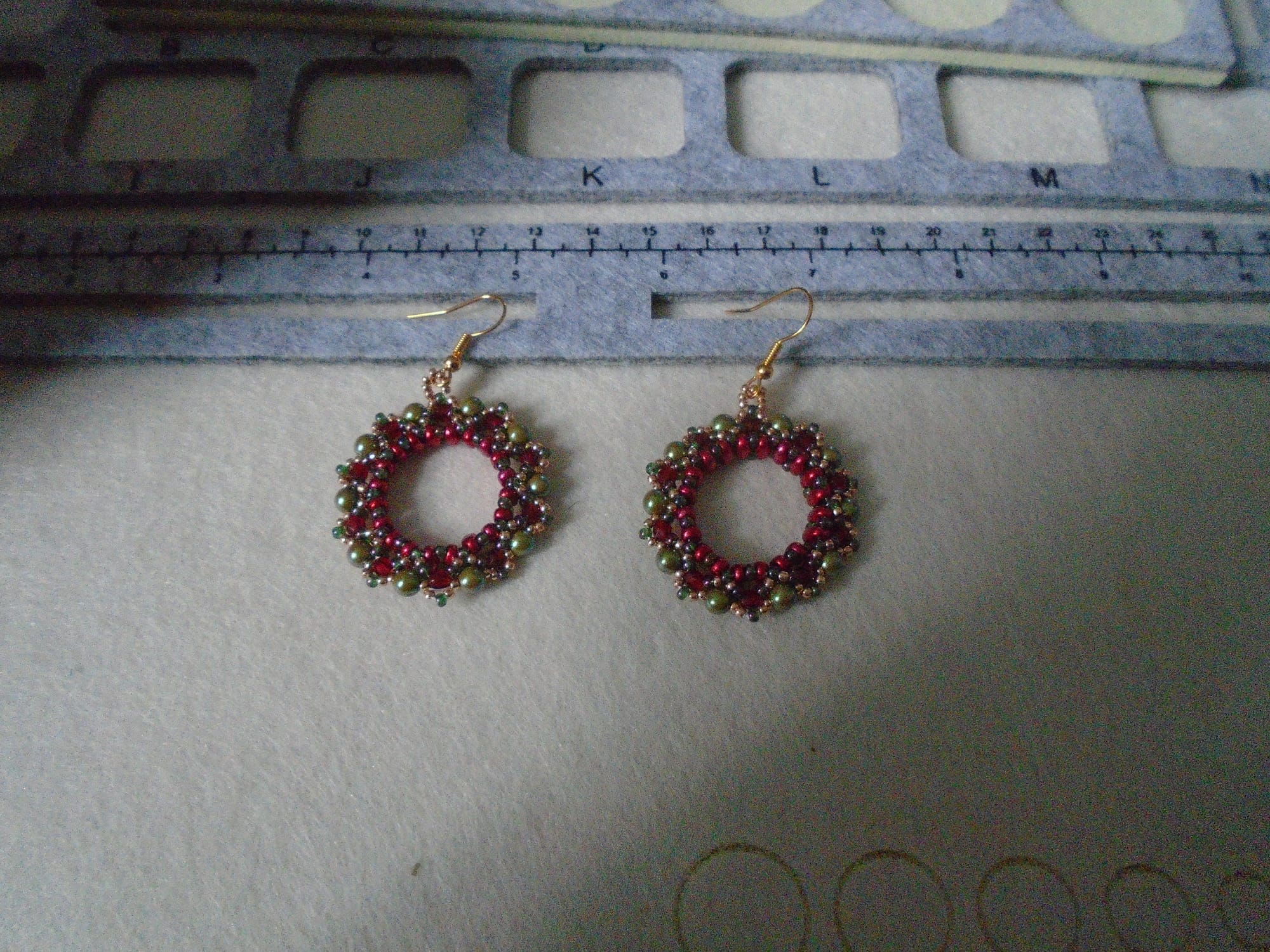Another pair of wreath-style earrings in red and olive.