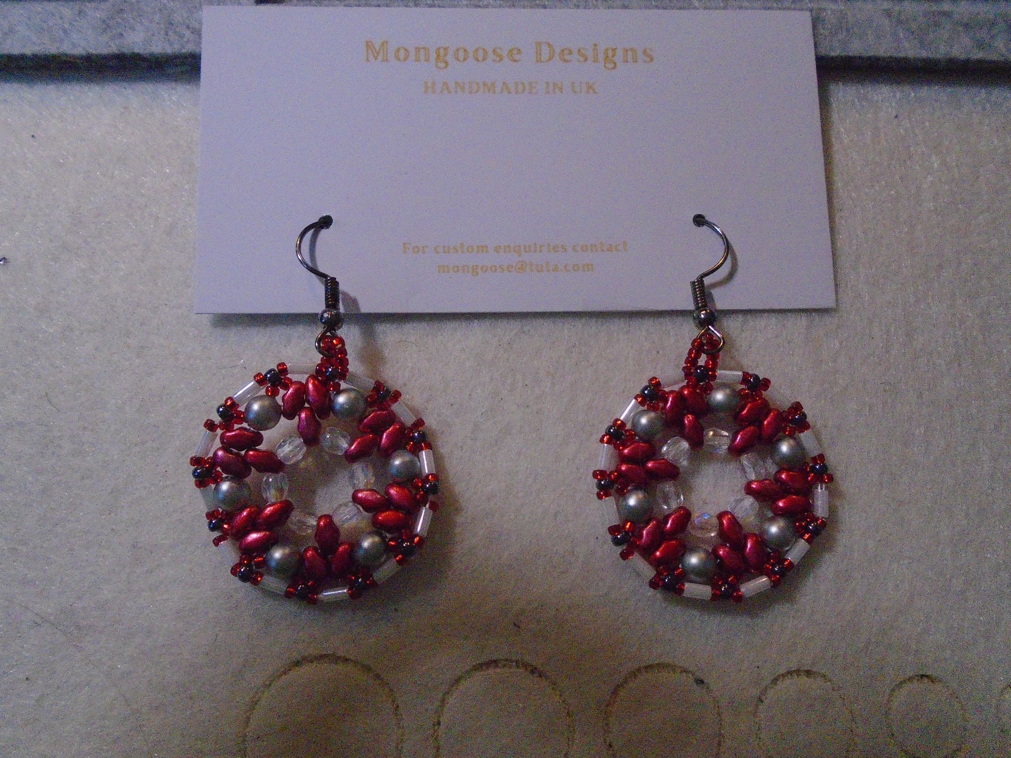 1920s-style earrings in red and greyscale, with gunmetal earwires.