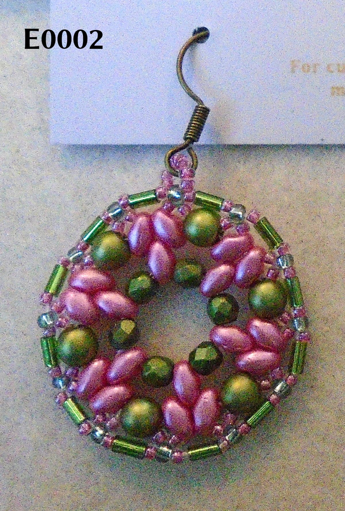 Rose pink and olive green 1920s-style earring on antique bronze earwire. The photo is labelled "E0002".