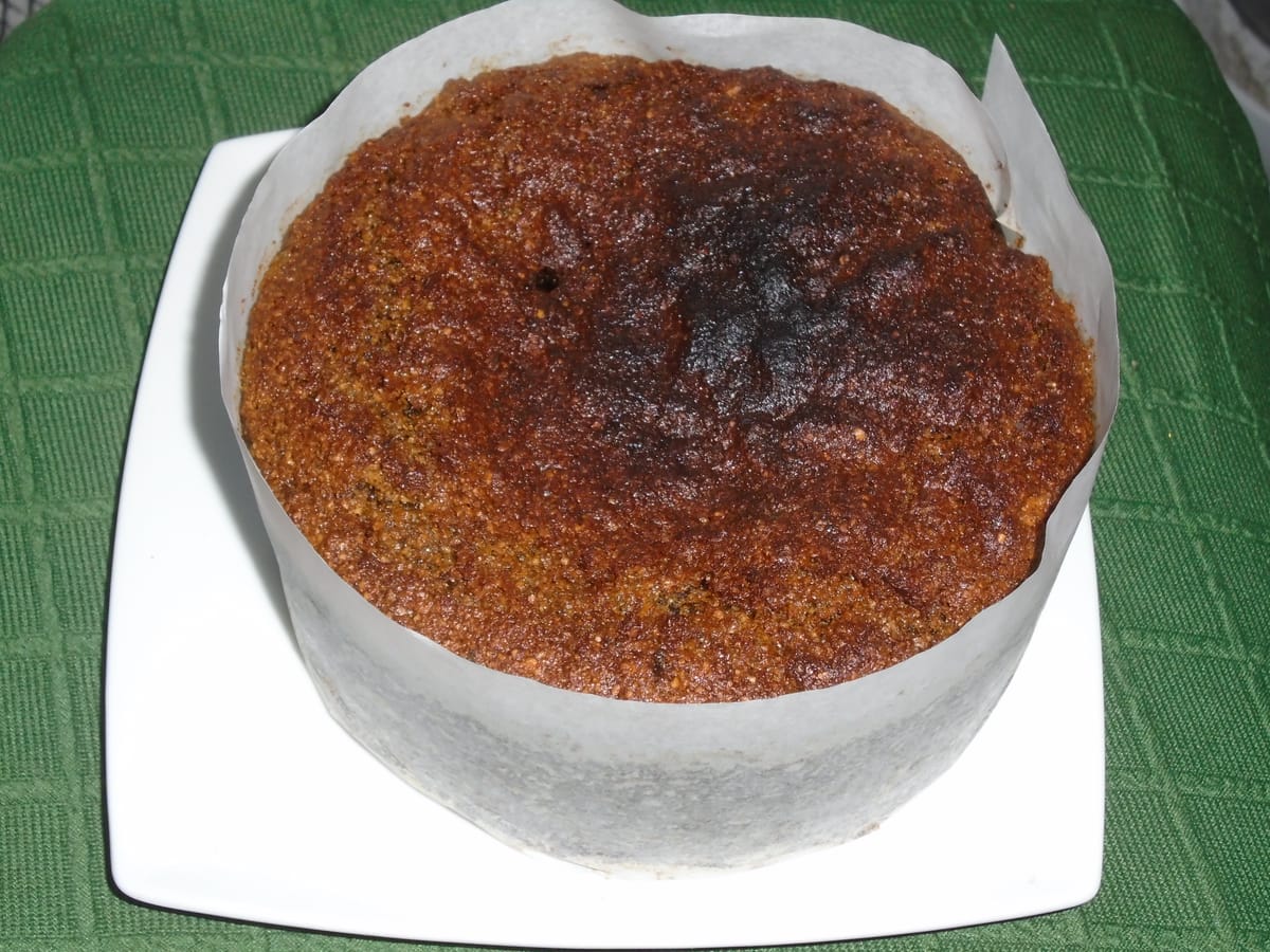 A round parkin, with just a hint of burning on the top, risen almost to the top of the paper used to line the tin.