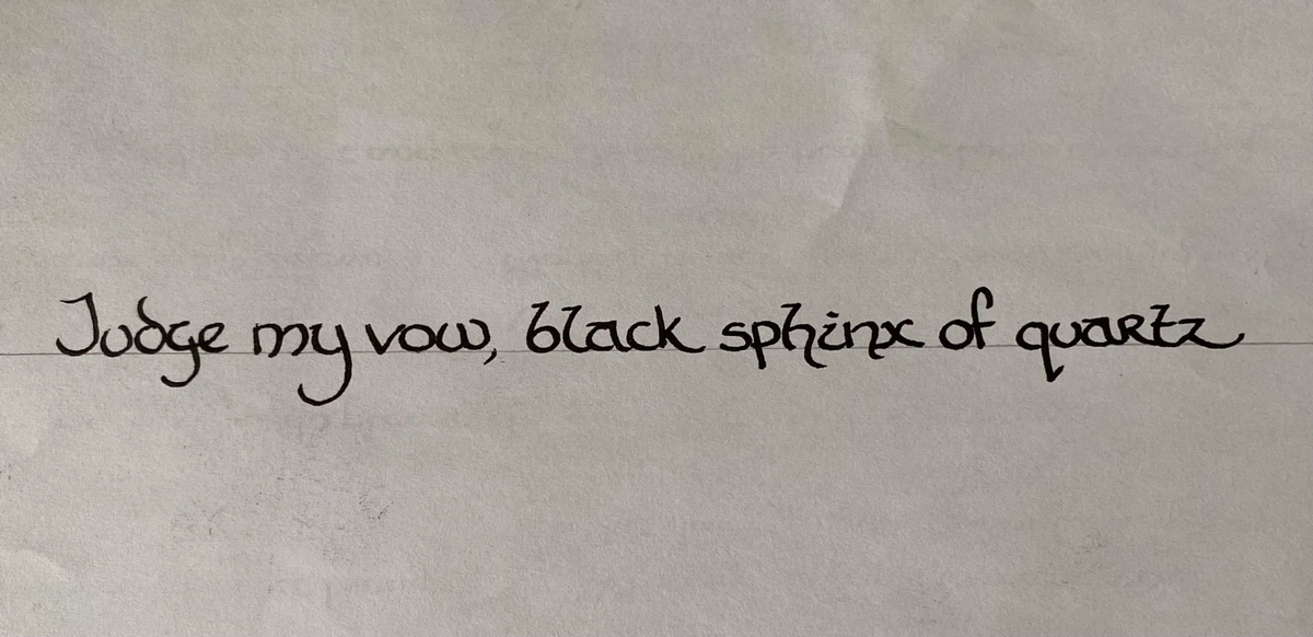The text reads: "Judge my vow, black sphinx of quartz", which contains every letter of the alphabet.