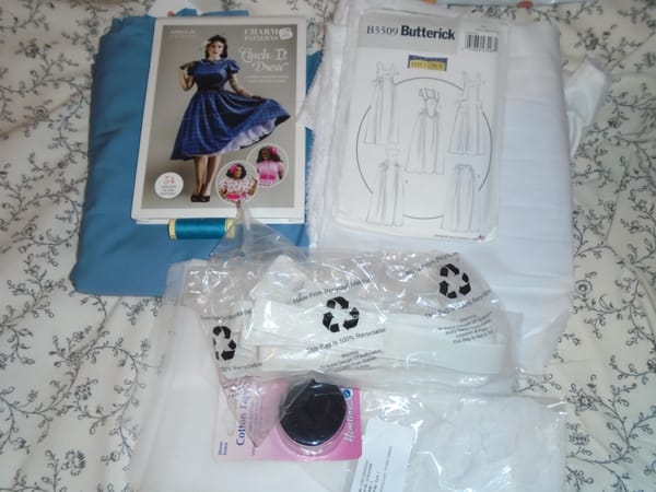 Dress and pinafore patterns, fabric, thread, dress net, lining, elastic, and cotton tape (that's for the playing cards).