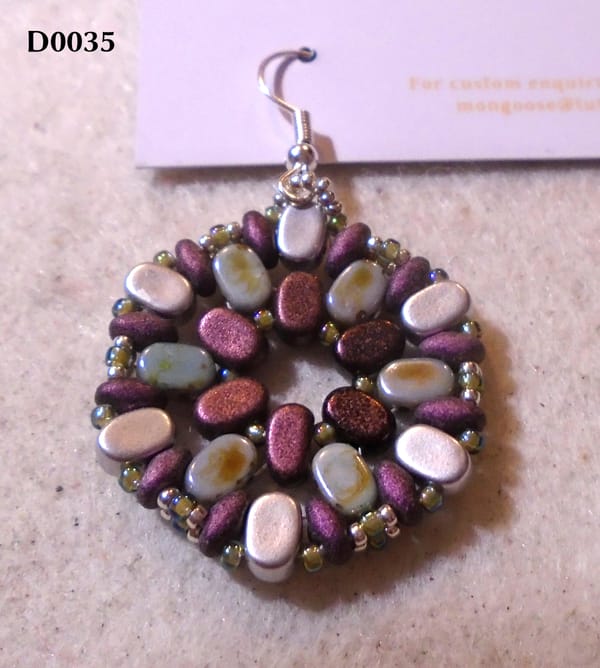 Hexagonal earring in deep reddish-purple, silver, and a very desaturated blue with coppery splashes.