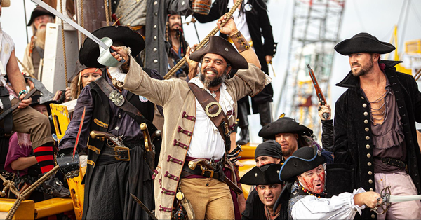 A group of pirates wearing frock coats, lace-up shirts, and awesome hats