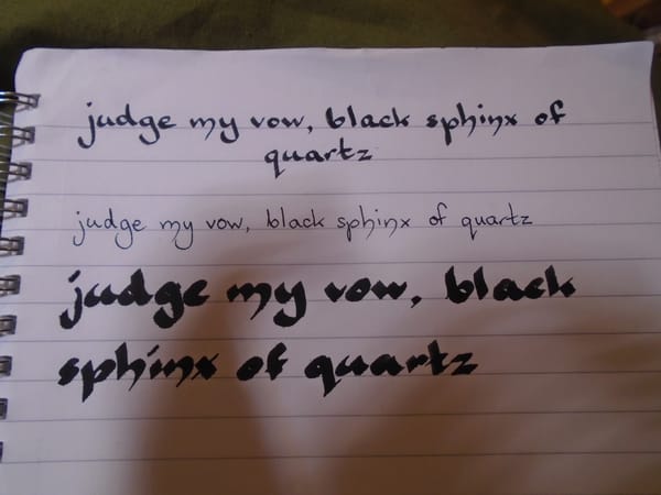 The sentence "judge my vow, black sphinx of quartz" written in three different nib thicknesses.