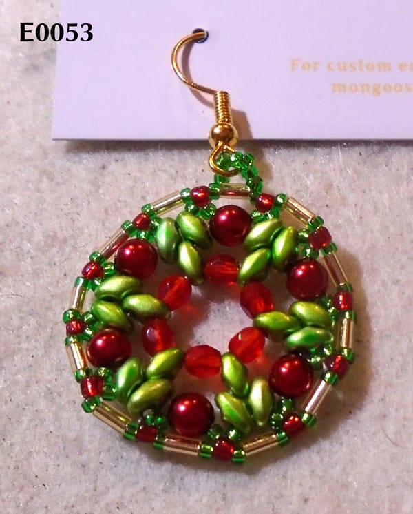 A very Christmassy-looking 1920s-style earring in red, green, and gold.