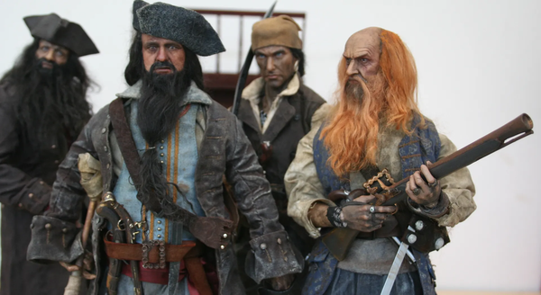 Four pirates; three of them look very fierce, but the one in the foreground looks horror-stricken for some reason.