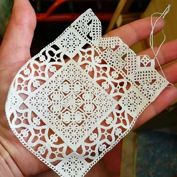The lace is quite geometric and looks similar to a woven fabric with cutwork.  It's not; it's all needle-made.