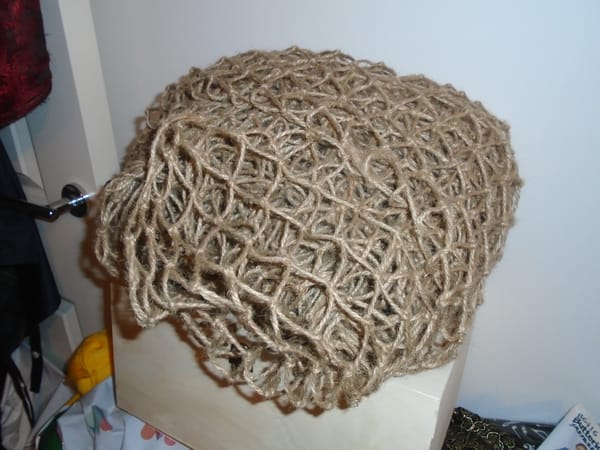 This net is brown jute twine, and it is all bundled up.  The whole thing is the size of a large cushion.