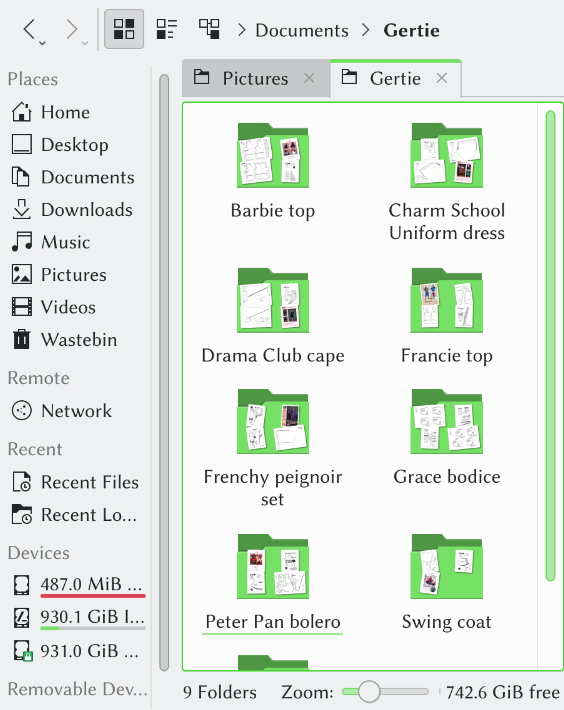 Folders showing two tops, one cape, one dress, one bodice, one peignoir set, one bolero, and one coat.